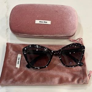 Black Miu Miu sunglasses with white stars.